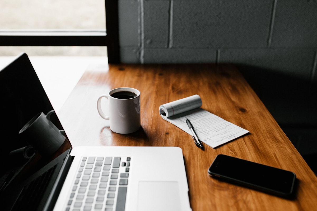 Laptop and coffee on a wooden table